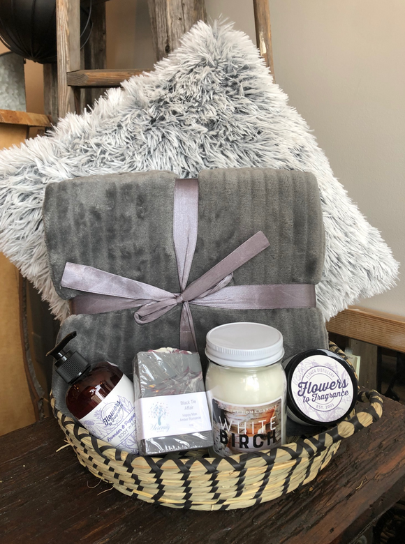 The perfect cozy basket with a soft throw, toss cushion, locally made candle, body butter, wash and soap.